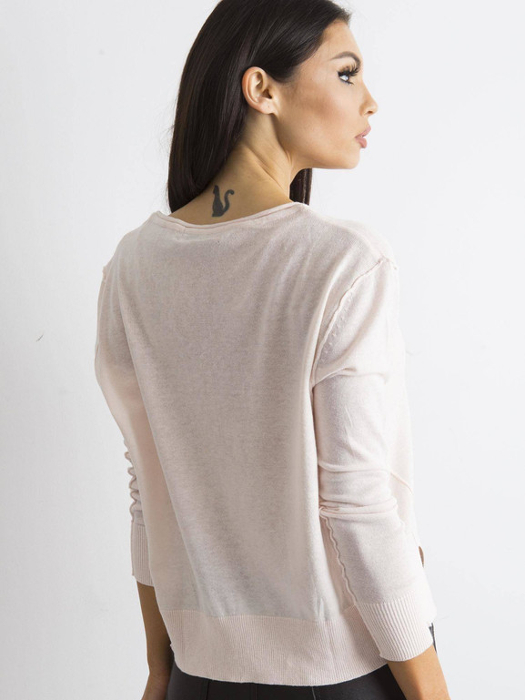 Jasnoróżowy sweter z dekoltem w serek